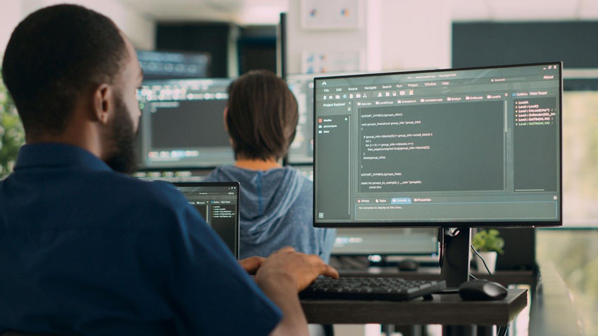 African software engineering intern coding on a computer during a tech internship